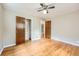 A well-lit room has a ceiling fan, hardwood floors, closets, and access to other rooms at 2565 S Gaylord St, Denver, CO 80210