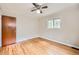 Neutral bedroom with ceiling fan, hardwood floors, and a window for natural light at 2565 S Gaylord St, Denver, CO 80210