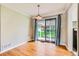 Sunny dining area featuring hardwood floors and a sliding door for easy outdoor access at 2565 S Gaylord St, Denver, CO 80210