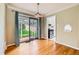 Dining space with sliding glass doors to backyard and view into kitchen at 2565 S Gaylord St, Denver, CO 80210