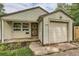 Close-up of a charming home with tidy siding, a secure front door, and attached garage at 2565 S Gaylord St, Denver, CO 80210