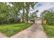 Beautiful home with lush lawn, driveway, and mature trees, exuding a welcoming atmosphere at 2565 S Gaylord St, Denver, CO 80210