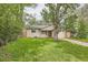 Charming home featuring a well-manicured front yard and mature trees creating a peaceful curb appeal at 2565 S Gaylord St, Denver, CO 80210