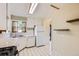 Functional kitchen with tile floors, neutral cabinets and countertops at 2565 S Gaylord St, Denver, CO 80210