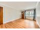 Bright living room featuring polished wood floors, crown molding, and ample natural light at 2565 S Gaylord St, Denver, CO 80210