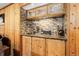 Home bar area with wooden cabinets, mosaic backsplash, and a dedicated wine storage and serving area at 8866 E Easter Ave, Centennial, CO 80112