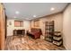 Basement featuring wood look floors, a futon, and a sliding barn door at 8866 E Easter Ave, Centennial, CO 80112