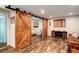 Basement featuring wood look floors and sliding barn door at 8866 E Easter Ave, Centennial, CO 80112
