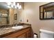 Bathroom vanity featuring granite countertop and decorative backsplash at 8866 E Easter Ave, Centennial, CO 80112