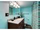 Well-lit bathroom with a granite countertop, wooden cabinets, and updated faucet at 8866 E Easter Ave, Centennial, CO 80112