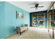 Cozy bedroom features neutral carpeting, bench seating, and glass doors leading to balcony at 8866 E Easter Ave, Centennial, CO 80112