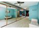 Spacious bedroom featuring plush carpeting, mirrored closet doors, and updated ceiling fan at 8866 E Easter Ave, Centennial, CO 80112