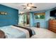 Bright bedroom with blue walls, a ceiling fan, and a mirrored closet, provides ample storage space at 8866 E Easter Ave, Centennial, CO 80112