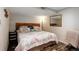 Comfortable bedroom with wood flooring, featuring a queen-size bed and a wall mirror at 8866 E Easter Ave, Centennial, CO 80112