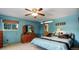 A blue bedroom features a ceiling fan, carpet, window, and light-colored bedding on a made bed at 8866 E Easter Ave, Centennial, CO 80112