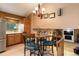 Charming dining area with a chandelier, granite counters, and seamless flow to the living area at 8866 E Easter Ave, Centennial, CO 80112