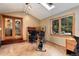 Bright exercise room featuring a skylight, large window, and a stationary bike and desk at 8866 E Easter Ave, Centennial, CO 80112