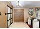 Inviting foyer features light tile flooring, a statement table, and a decorative sliding panel door at 8866 E Easter Ave, Centennial, CO 80112