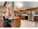 Spacious kitchen featuring stainless steel appliances, granite countertops, and breakfast bar at 8866 E Easter Ave, Centennial, CO 80112