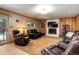 Cozy living room boasts a brick fireplace, plush leather seating, and sliding door access to the outdoors at 8866 E Easter Ave, Centennial, CO 80112