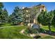 Attractive apartment building with manicured lawn and mature trees on a beautiful sunny day at 3035 Oneal Pkwy # 35T, Boulder, CO 80301