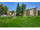 Expansive lawn area on the property with mature trees and well maintained apartment buildings at 3035 Oneal Pkwy # 35T, Boulder, CO 80301
