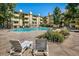 Inviting community pool area with lounge chairs, flowers and foliage, perfect for summer relaxation at 3035 Oneal Pkwy # 35T, Boulder, CO 80301