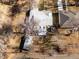 Overhead shot of a home with a neutral roof, complemented by mature trees and a detached garage in a peaceful setting at 3145 S Ash St, Denver, CO 80222