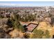 Aerial view of the community tennis courts, neighborhood and tree lined walking path, and active residents at 3145 S Ash St, Denver, CO 80222