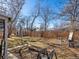 View of a back yard with a brown lawn surrounded by a new wooden fence and some trees at 3145 S Ash St, Denver, CO 80222