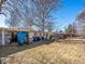 Image of the back of the house with lawn, chairs, and trash cans at 3145 S Ash St, Denver, CO 80222