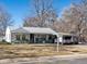 Comfortable single story home with a green porch, attached car port, and a traditional lawn at 3145 S Ash St, Denver, CO 80222