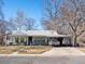 Inviting single story home with a green porch, car port, and a lush lawn at 3145 S Ash St, Denver, CO 80222