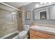 This bathroom features a glass shower, tile walls, a modern vanity with sink, and a large mirror at 32209 Blue Springs Dr, Evergreen, CO 80439