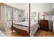 Bedroom with hardwood floors, four-poster bed, and natural light from the window at 32209 Blue Springs Dr, Evergreen, CO 80439