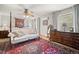 Bright bedroom with a canopy bed, hardwood floors, and large windows providing ample natural light at 32209 Blue Springs Dr, Evergreen, CO 80439