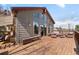 Expansive wooden deck with mountain views, featuring comfortable outdoor seating and log cabin architecture at 32209 Blue Springs Dr, Evergreen, CO 80439