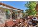 Spacious deck with outdoor seating, dining area, awning and access to indoor living spaces at 32209 Blue Springs Dr, Evergreen, CO 80439