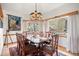 Formal dining room features an elegant chandelier and windows with views of a beautiful mountain at 32209 Blue Springs Dr, Evergreen, CO 80439
