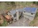 Stunning mountain home featuring solar panels, stone chimney, and a large deck perfect for outdoor living at 32209 Blue Springs Dr, Evergreen, CO 80439