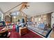 Spacious living room features vaulted ceilings, hardwood floors, and access to a covered outdoor patio at 32209 Blue Springs Dr, Evergreen, CO 80439