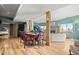 Open-concept living and dining area with hardwood floors, fireplace, and access to other rooms at 32209 Blue Springs Dr, Evergreen, CO 80439