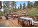Expansive outdoor patio area with plenty of seating, dining space, and picturesque mountain views at 32209 Blue Springs Dr, Evergreen, CO 80439