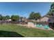Spacious backyard with a storage shed, patio, and well-maintained lawn at 12143 Dahlia Dr, Thornton, CO 80241