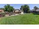 Expansive backyard featuring a well-kept lawn, patio seating area, and storage shed at 12143 Dahlia Dr, Thornton, CO 80241