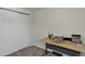 Bedroom features a desk and a closet with sliding doors at 12143 Dahlia Dr, Thornton, CO 80241