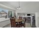 Bright dining area with wood table, a view from the windows, and modern lighting at 12143 Dahlia Dr, Thornton, CO 80241