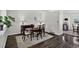 A dining room featuring an oval table, dark wood flooring, and decorative lamps at 12143 Dahlia Dr, Thornton, CO 80241