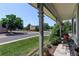 Inviting front porch with charming garden view and outdoor seating at 12143 Dahlia Dr, Thornton, CO 80241