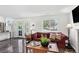 Bright living room with dark floors, large windows, and elegant furniture arrangement at 12143 Dahlia Dr, Thornton, CO 80241